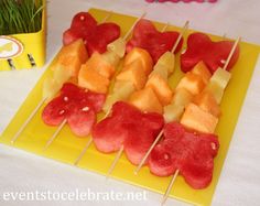 watermelon and pineapple skewers on a yellow plate