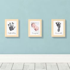 three framed pictures with baby's hand and foot prints on them in a room