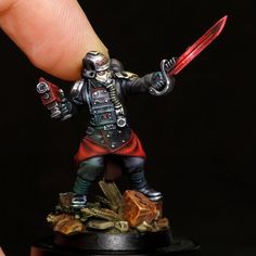 a miniature figurine holding a knife in his hand