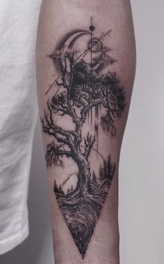 a man's arm with a tree tattoo on it