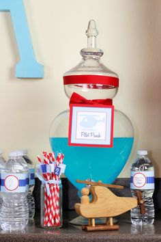 a table topped with lots of water bottles and items on top of a wooden sleigh