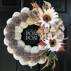 a wreath that has flowers on it and the words pom pom written in black