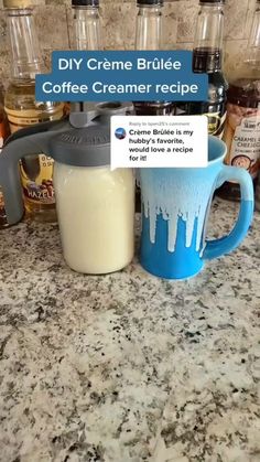 a coffee mug sitting on top of a counter next to other bottles and containers with liquid in them