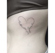 a woman's stomach with a heart shaped tattoo