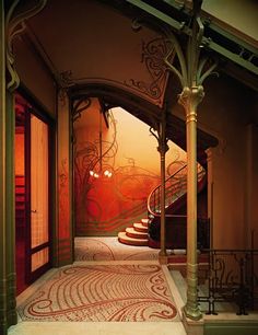 the entrance to a building with an intricately designed floor and staircase leading up to it