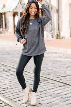 This cable knit top is the definition of versatility! You can style this relaxed fit top with leggings and sneakers for a causal day of running errands or swap the sneakers for house shoes for those days where leaving the house just isn't in the cards! But don't let its coziness fool you! You can also dress this light cable knit top up for any occasion you want to look casually cute! Pair it with jeans, booties, and throw on some layered necklaces for a look that you will feel very trendy in! Th Comfy Everyday Knit Tops, Comfy Knit Tops For Everyday, Fall Casual Comfortable Tops, Casual Cozy Fit Cable Knit Tops, Gray Athleisure Sweater For Fall, Casual Cable Knit Top With Cozy Fit, Casual Cable Knit Tops For Loungewear, Casual Relaxed Fit Cable Knit Top, Casual Cable Knit Top With Relaxed Fit