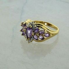 Vintage 10K Yellow Gold Amethyst and Diamond Ring, 4.5x8mm marquis center, 11 amethyst stones, 2 diamond accent, Ring size 7, Circa 1960, 3.2 grams Stock # BB254R22 This listing contains photographs of the actual item you will receive. Our items are in excellent condition with little or no signs of wear and many are one of a kind pre-owned estate finds. Please look closely at the pictures in this listing as they are part of the product description. Please read the description, as any imperfectio Vintage Marquise Gemstone Cluster Ring, Vintage Multi-stone Marquise Cut Jewelry, Vintage Marquise Cut Multi-stone Jewelry, Classic Marquise Amethyst Anniversary Ring, Classic Marquise Amethyst Ring For Anniversary, Yellow Gold Marquise Amethyst Ring For Anniversary, Gold Amethyst Marquise Cut Ring For Anniversary, Gold Marquise Cut Amethyst Ring For Anniversary, Purple Marquise Cut Amethyst Ring For Formal Occasions