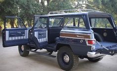 an old jeep is parked in the driveway