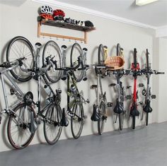 there is a bike rack with many bikes hanging on the wall next to it,