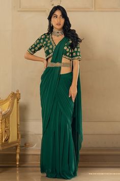 Emerald green georgette pre-stitched saree with pleats. Comes with a tussar silk padded blouse with floral motifs, sequins and zari hand embroidery and a belt - Aza Fashions Luxury Green Pre-draped Saree With Traditional Patterns, Luxury Green Pre-draped Saree For Traditional Ceremonies, Luxury Green Pre-draped Saree For Formal Occasions, Luxury Green Pre-draped Saree For Wedding, Affordable Green Pre-draped Saree For Festivals, Luxury Pista Green Anarkali Pre-draped Saree, Cheap Green Saree With Traditional Drape, Luxury Green Pre-draped Saree For Formal Events, Luxury Green Bollywood Pre-draped Saree