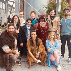 a group of people dressed in costumes posing for a photo