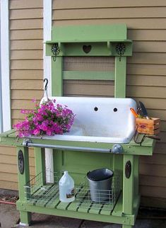 a sink and some flowers in front of a house