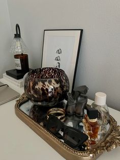 a tray that has some items in it on top of a table next to a lamp