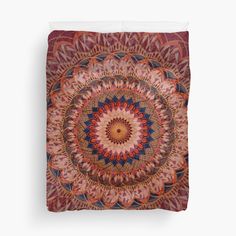 a red and blue circular design on a white background duvet cover with an intricate flower pattern