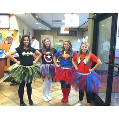 four girls dressed up as superheros posing for the camera