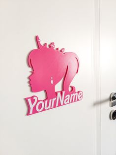 a door with a pink sign that says your name on it and an elephant head