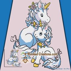 a cross stitch unicorn and her baby on the back of a blue background with text that says hooked creations