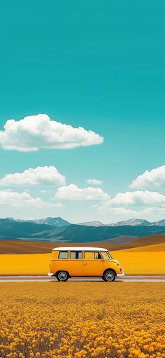 a yellow van driving down a road in the middle of a wheat field with mountains in the background