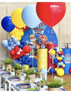 a party with balloons and decorations for a paw patrol themed birthday party on a table