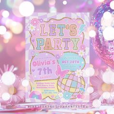 a pink and gold birthday party with disco ball on the table next to it is a card that says, let's party