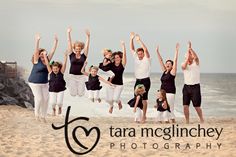 a group of people jumping in the air at the beach