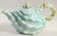 a ceramic tea pot with a starfish on it