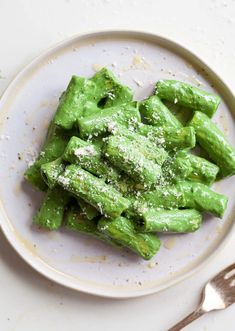 a white plate topped with broccoli covered in powdered sugar