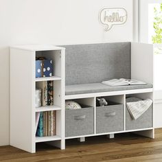 a white book shelf with baskets and books