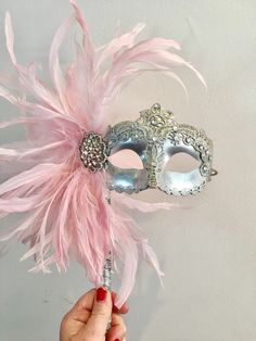 "Women's Mask- feather mask- Mardi Gras -Holiday Mask -Halloween -Masked ball -Masquerade Party mask- NYE Hello, This feather stick mask is a stunning stopper and is made with pink coque feathers are about to 8\". (Feathers vary) They fan out and are placed on a beautiful golden mask with lace overlay. Mask colors: A) Gold solid (in VIDEO) B) Gold/ tan crackle C) Silver solid (first photo) D) Silver/ tan crackle Black Rose gold The huge rhinestone setting that is 4 inches with rhinestone that ma Halloween Masked Ball, Pink Masquerade Mask, Pink Masquerade, Golden Mask, Masquerade Party Decorations, Carnival Makeup, Feather Mask