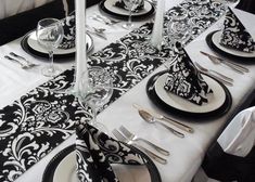 the table is set with black and white place settings