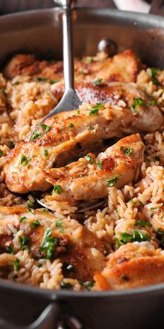 chicken and rice in a skillet with a spoon