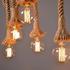 three light bulbs with rope hanging from them