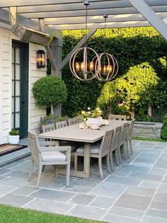 an outdoor dining area with table and chairs