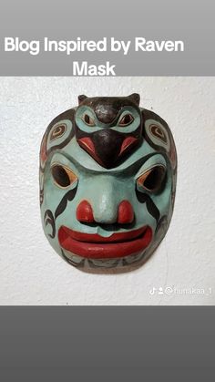 a mask hanging on the wall with words above it that read, blog inspired by raven mask