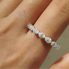 a woman's hand with a diamond ring on it