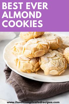 a white plate topped with cookies covered in powdered sugar on top of a table