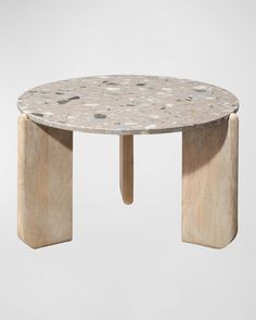 a table made out of wood and stone with an oval design on the top, sitting in front of a white background