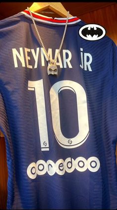 a blue jersey with the number 10 on it is hanging from a wooden hanger