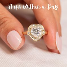 a woman's hand holding a diamond ring with the words ships within a bag