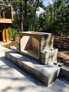 a cement bench sitting in the middle of a park