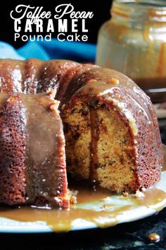 a bundt cake with caramel icing on a plate next to a jar of peanut butter