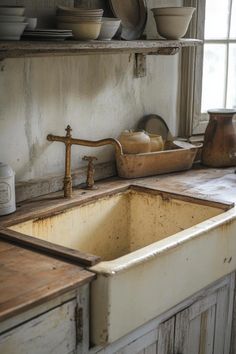 an old kitchen sink in front of a window