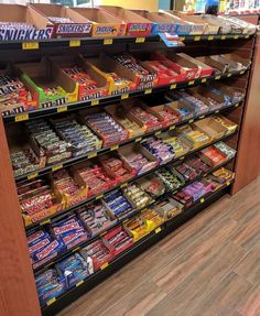 a display case in a store filled with lots of different types of candy and snacks