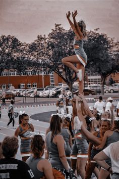 a group of cheerleaders standing on top of each other