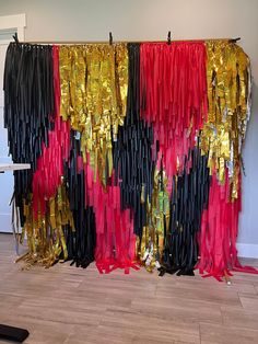 the curtain is decorated with red, black and gold streamers on it's side