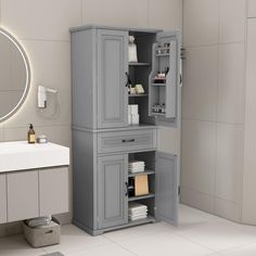 a bathroom with a sink, mirror and cabinet in it's corner area on the floor