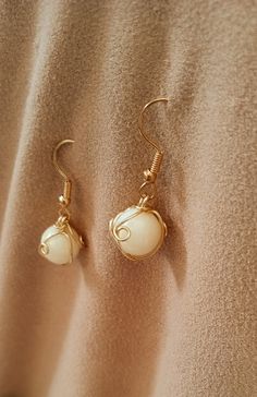 These ball earrings are a beautiful, rich, creamy shade of beige.  Each ball is wire wrapped in several gold tone tendrils. Ears Pierced, Salem Ma, Ball Earrings, Shades Of Beige, Vanilla Cream, French Vanilla, White Beige, Ear Piercings, Wire Wrapped