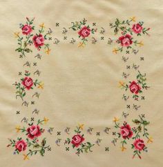 an embroidered piece of cloth with flowers on it