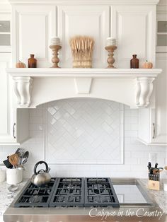 a stove top oven sitting inside of a kitchen next to a wall mounted range hood