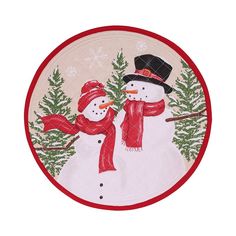 a snowman with a red scarf and hat is standing in front of some trees